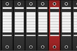 red file folder among black folders