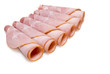 Slices of tasty ham on white dish. Shallow depth of field