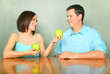 Kind Girlfriend Offering Green Apple To Young Male Caucasian