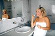 girl in bathroom with toothbrush and mirror