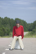 young man sitting on empty gas can