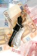 wedding couple figurine over euro notes