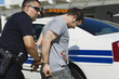 Police Officer Arresting Young Man