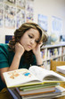 High School Student Reading in Library