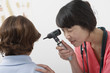 Young female doctor examining boy