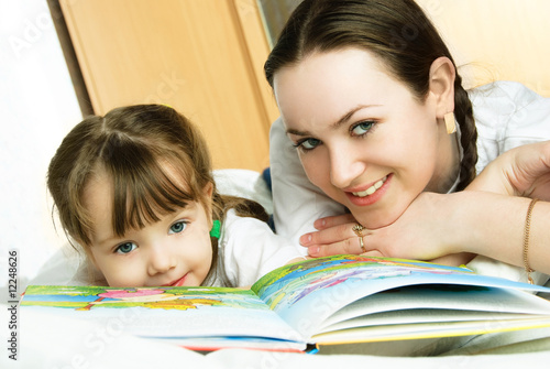 mother and daughter reading a book