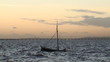 Small fishing boat in rough sea at sunset Small fishing boat in rough sea at sunset