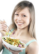Portrait of young happy woman eating salad