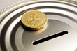 Pound coin on money box