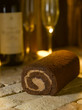 Swiss roll on brick with wine glasses and bottle