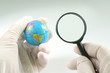 Earth globe & human hand
