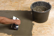 Applying adhesive for floor tiles
