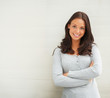 Portrait of a beautiful woman standing against a wall
