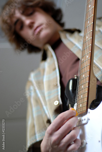 Photo: fourteen year old boy playing electric guitar fourteen year old boy playing electric guitar