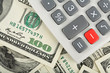 calculator with minus red button over dollars