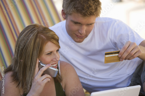 Photo: Couple Making Credit Card Purchase Couple Making Credit Card Purchase