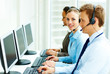 Photo: Happy business people working on separate computers Happy business people working on separate computers