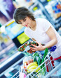 Happy young woman with her purchased grocery items