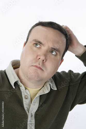 Photo: Man scratching head, looking up Man scratching head, looking up