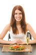 Woman eating salad with shrimp and pepper, isolated