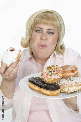 Photo: Woman Eating Donuts Woman Eating Donuts
