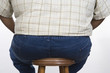 Overweight Man Sitting on Stool
