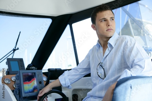 Photo: Young handsome man on a yacht boat interior Young handsome man on a yacht boat interior