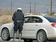 OFF ROAD MOTORCYCLE POLICEMAN HANDLING OUT TICKET-2-28-09-10 OFF ROAD MOTORCYCLE POLICEMAN HANDLING OUT TICKET-2-28-09-10