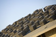 Close-up view of stacks of roof tiles on roof, construction site