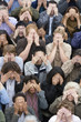 Crowd covering eyes