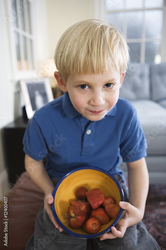 Photo: Portrait of boy with a bowl of strawberries.. Portrait of boy with a bowl of strawberries..