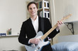Portrait of a man playing guitar.