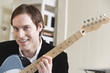 Portrait of a man holding guitar.