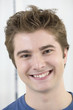 Portrait of a young man smiling.