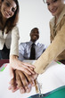 Foto: Business people sticking out hands together. Business people sticking out hands together.