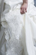 Midsection of bride wearing wedding gown.