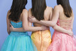 View of friends wearing prom dresses.