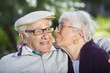Photo: View of a woman kissing a man. View of a woman kissing a man.