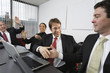 Photo: View of business people celebrating in an office. View of business people celebrating in an office.