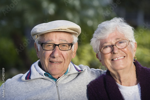 Photo: Portrait of a senior couple in a park. Portrait of a senior couple in a park.