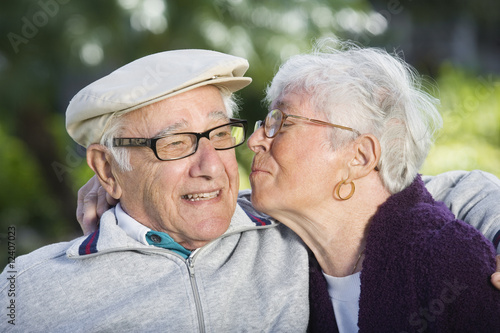 Photo: View of a woman kissing a man. View of a woman kissing a man.