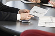 Foto: Close up of hands holding a blueprint. Close up of hands holding a blueprint.