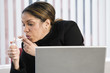 Photo: View of a business woman smoking in the office. View of a business woman smoking in the office.