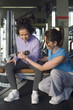 trainer assisting senior woman in weightlifting with dumbbell
