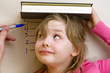 child watching herself get measured