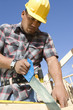 construction worker sawing on construction site