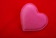 Pink heart close up isolated on red textured background. Pink heart close up isolated on red textured background.