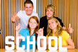 Young studentgroup studying in classroom, thumbs up