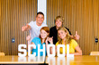 Young studentgroup studying in classroom, thumbs up