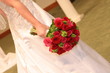 holding red flowers holding red flowers